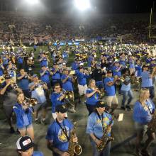 Band Alumni marching off the field