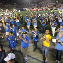 Band Alumni marching off the field
