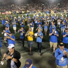 Band Alumni marching off the field