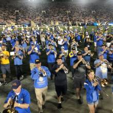 Band Alumni marching off the field